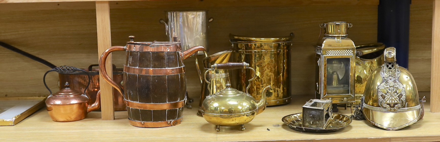 Sundry brass and copper, including a brass fireman’s helmet, a coal helmet, a staved and coopered wood and copper jug, a Victorian brass warming pan, a Victorian copper warming pan, a Victorian brass kettle etc.
